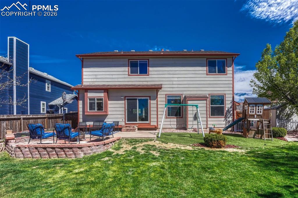 Image 40 of 40: Two-story exterior with siding, featuring a ground-level patio