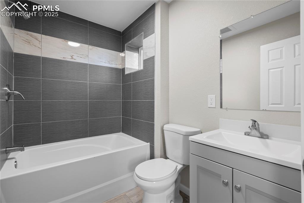 Image 14 of 25: Full bath featuring vanity and shower / tub combination