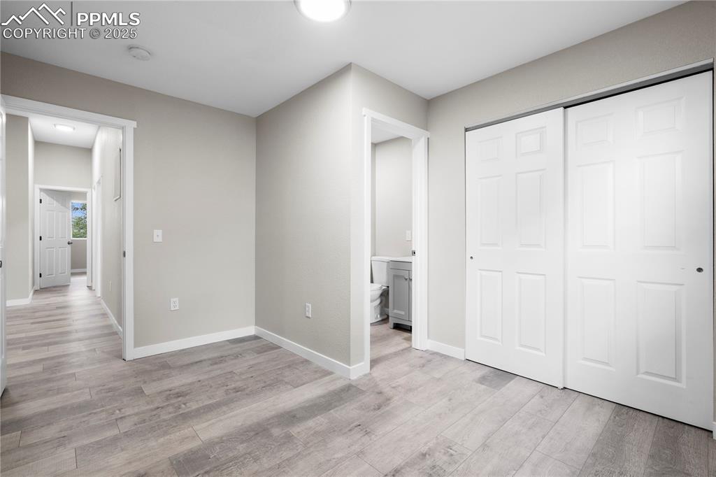 Image 15 of 25: Unfurnished bedroom featuring light wood-type flooring, a closet, and conne