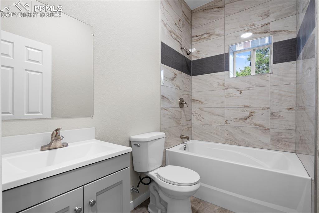 Image 19 of 25: Full bathroom with vanity and bathing tub / shower combination