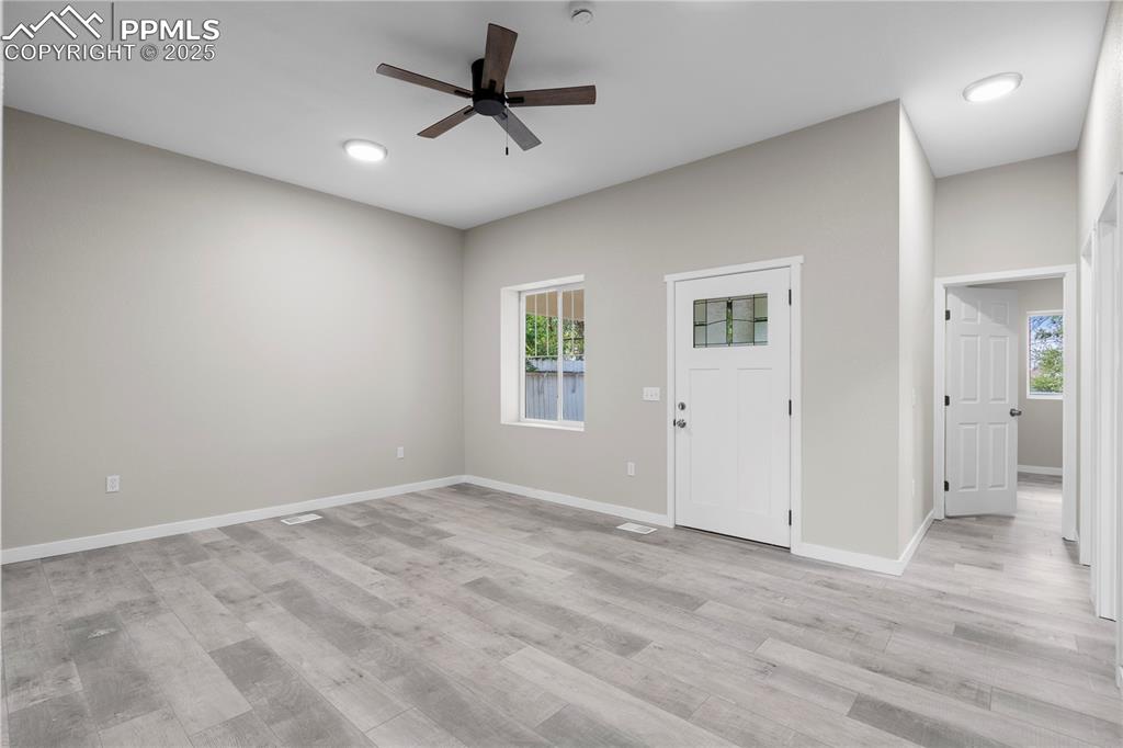 Image 23 of 25: Entrance foyer featuring plenty of natural light, ceiling fan, and light wo