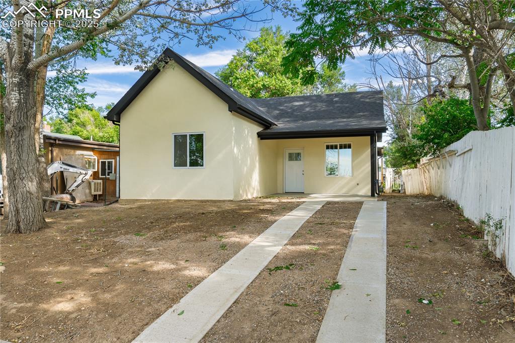 Image 5 of 25: Rear view of property with a shingled roof and stucco siding