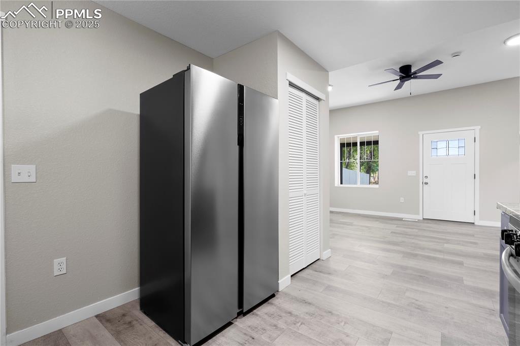 Image 6 of 25: Kitchen featuring freestanding refrigerator, light wood-type flooring, ceil