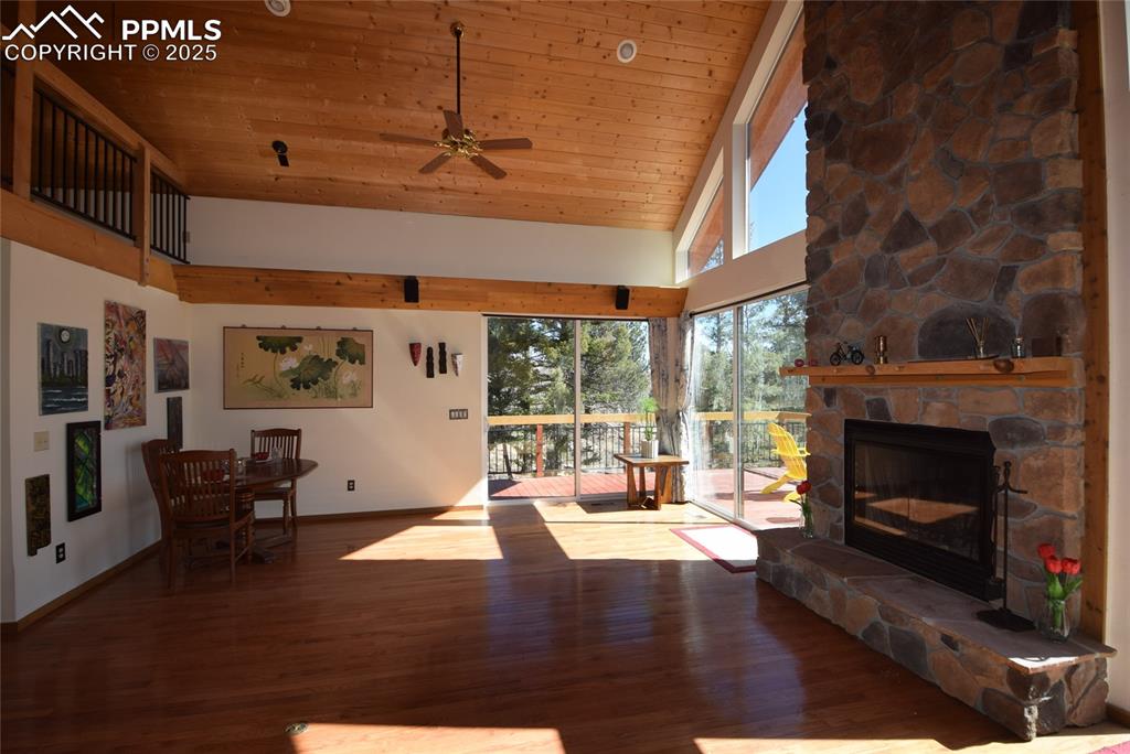Image 13 of 44: Living room featuring high vaulted ceiling, wooden ceiling, wood finished f