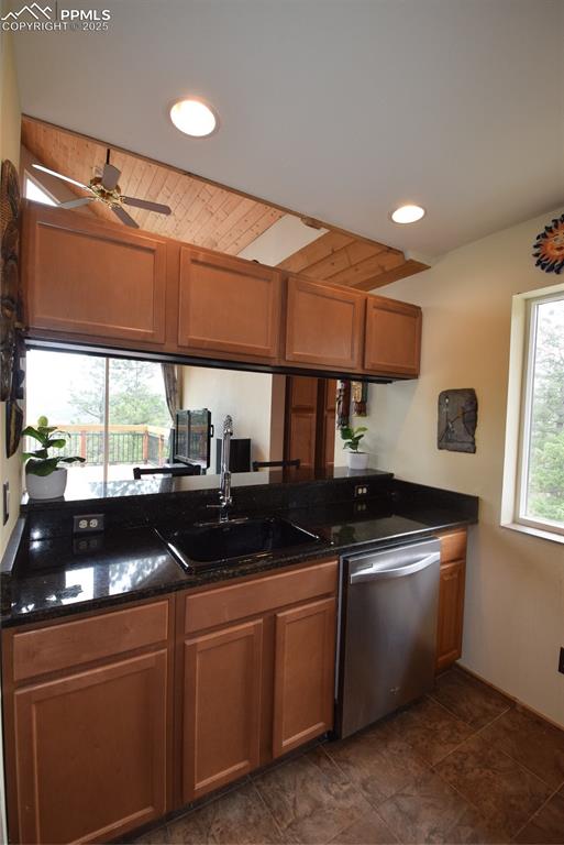 Image 17 of 44: Kitchen featuring dishwashing machine, brown cabinets, recessed lighting, d