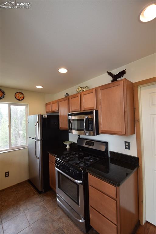Image 18 of 44: Kitchen featuring stove, stainless steel microwave, recessed lighting, brow