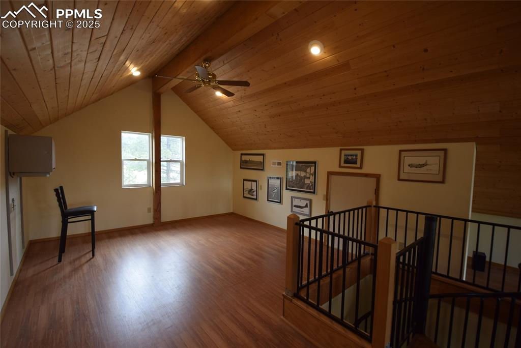 Image 19 of 44: Additional living space with wood finished floors, a ceiling fan, and woode