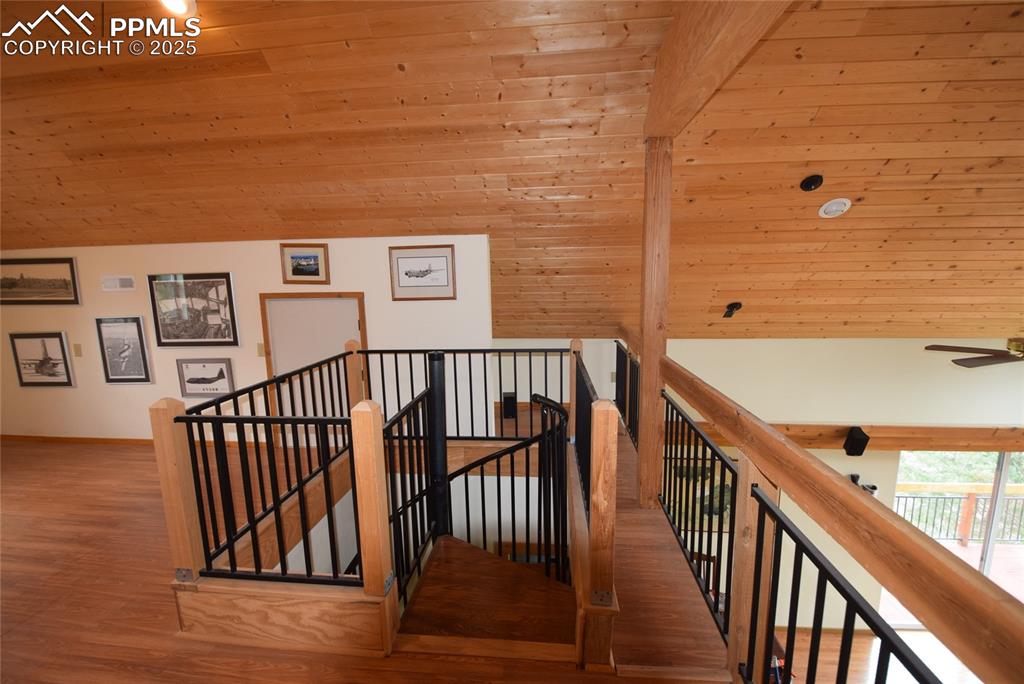 Image 20 of 44: Staircase with wood finished floors, wood ceiling, and a ceiling fan