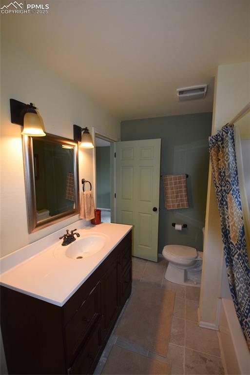 Image 27 of 44: Bathroom featuring vanity, light tile patterned floors, and shower / bath c