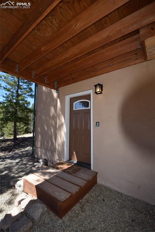 Image 29 of 44: Entrance to property featuring stucco siding