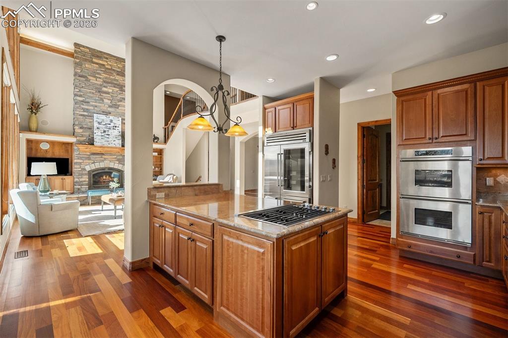 Image 11 of 40: Kitchen overlooking the great room, creating an open flow with beautiful si