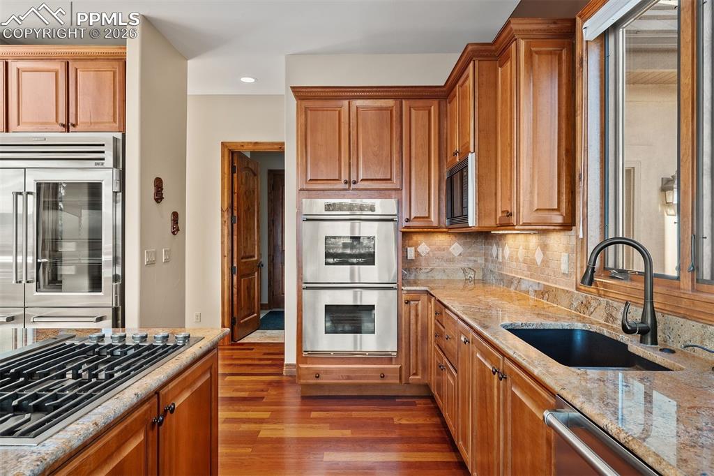 Image 12 of 40: Kitchen appointed with a Sub-Zero refrigerator, Dacor double ovens, a Wolf