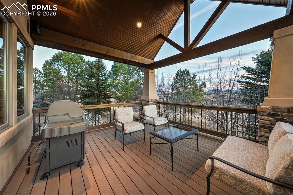Image 16 of 40: Covered deck with remarkable mountain views, creating an inviting setting f