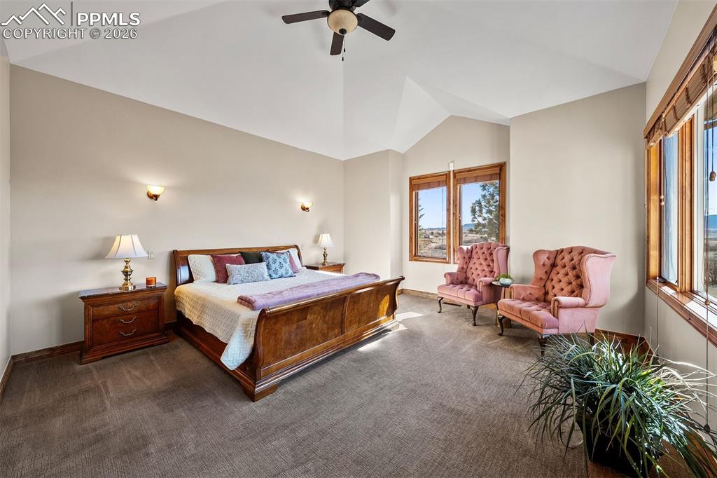 Image 18 of 40: A spacious primary suite with vaulted ceilings and mountain views offers a