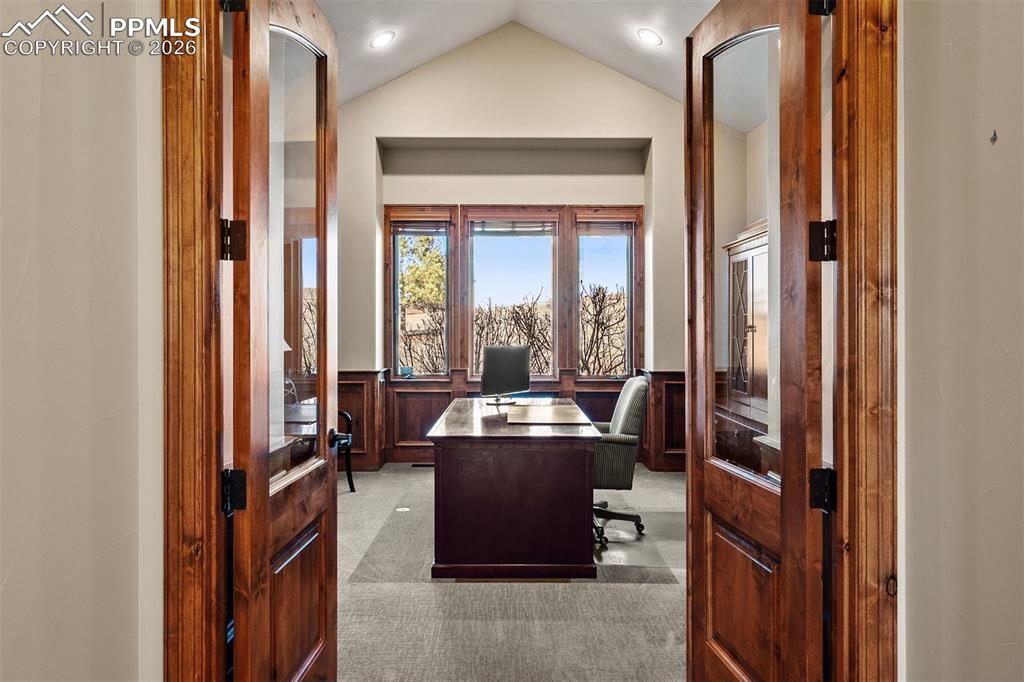 Image 23 of 40: French doors opening up to a large main level office/conforming bedroom.