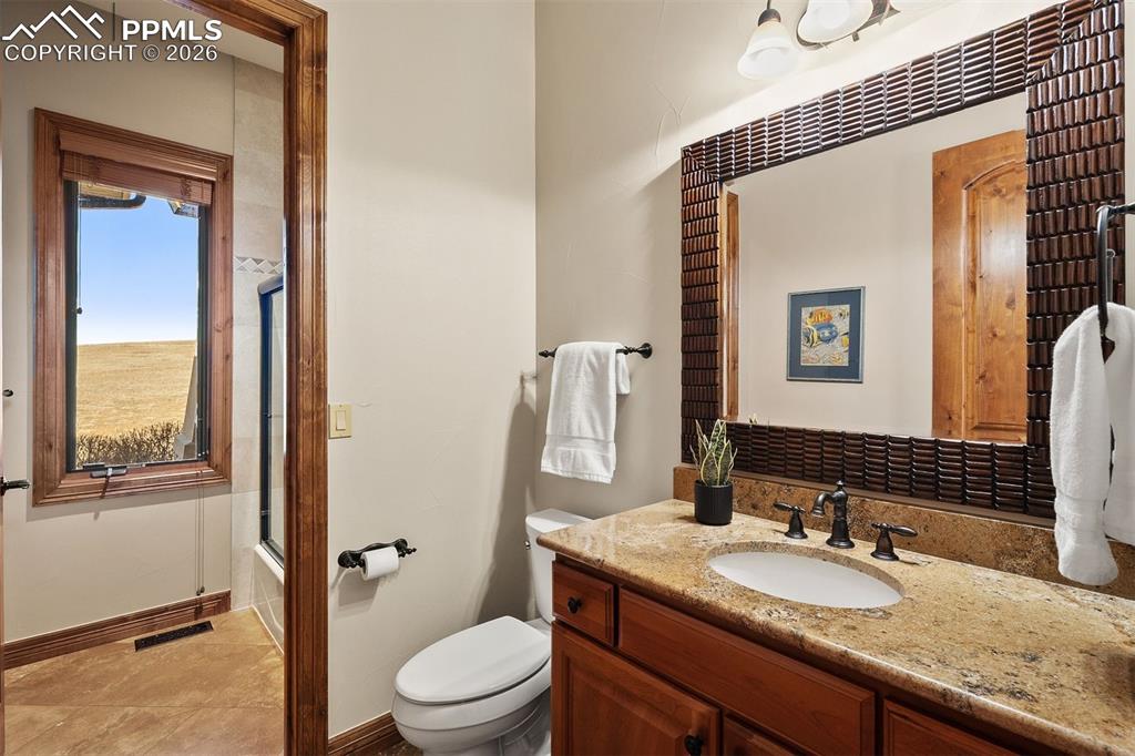 Image 25 of 40: Rare main level full bathroom with a single vanity and additional shower/tu