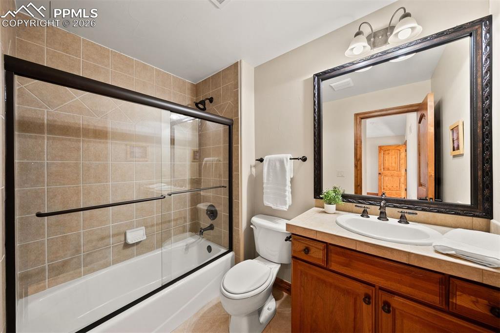 Image 29 of 40: Full bathroom en suite to bedroom 3 featuring a tiled shower with glass enc