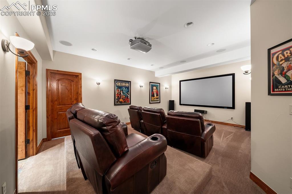 Image 34 of 40: Lower level media room/home theater with tiered seating, projection system,