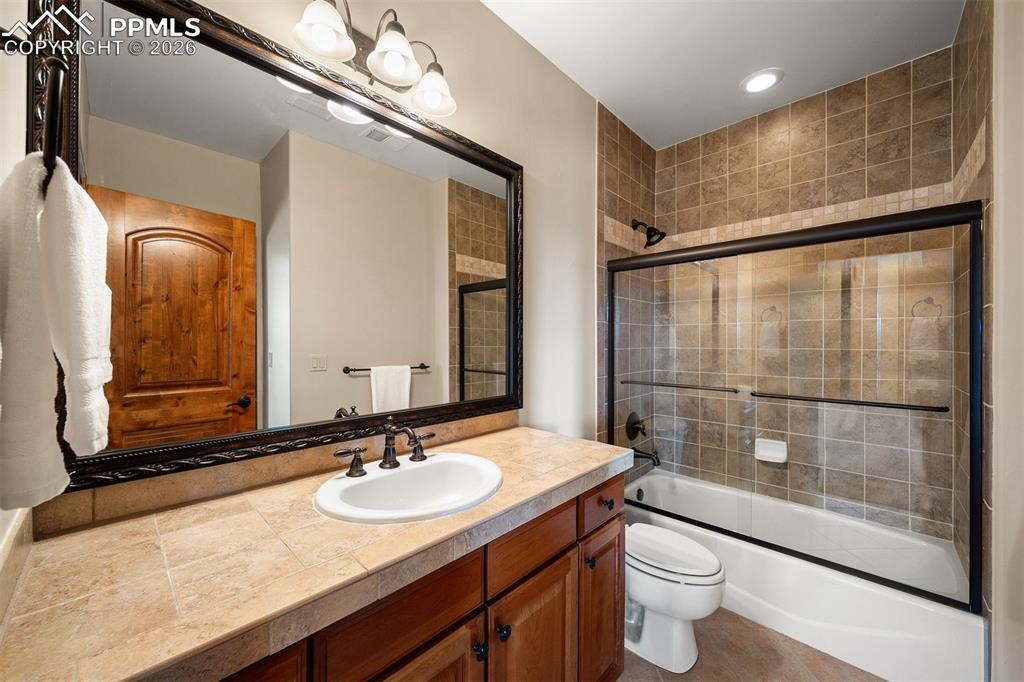 Image 38 of 40: Full bathroom en suite to bedroom 5 featuring a tiled shower surround, glas