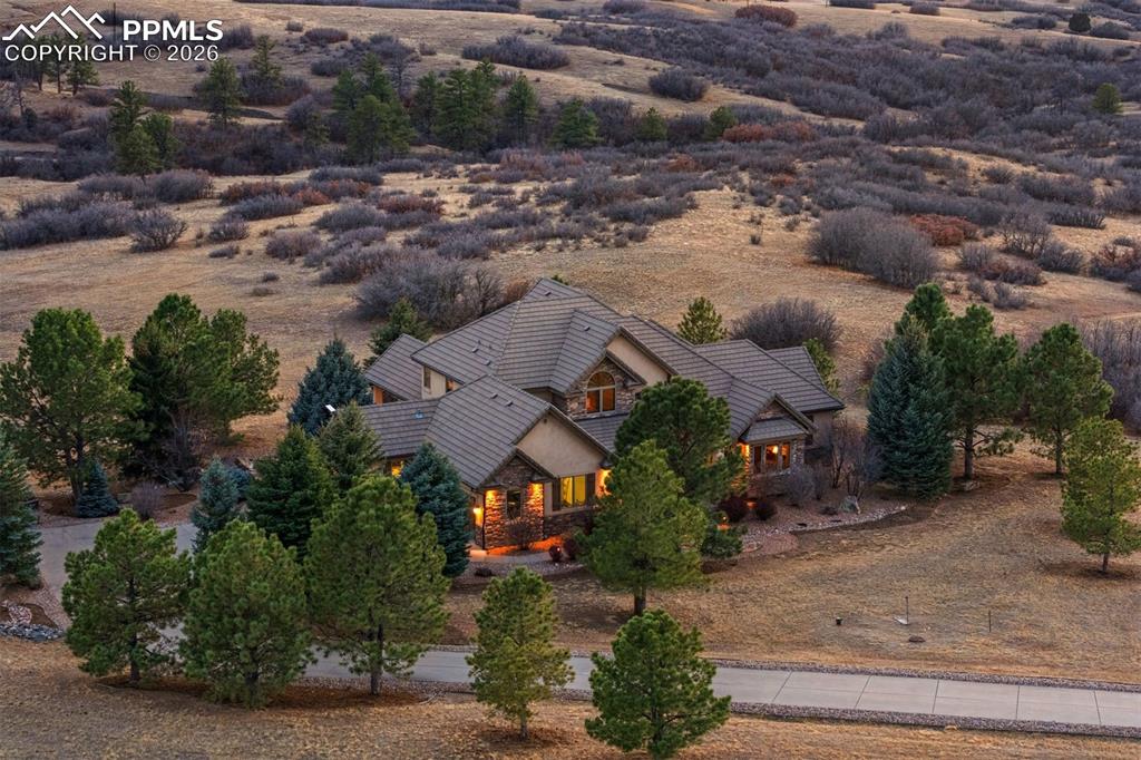 Image 39 of 40: Set on an expansive lot surrounded by rolling hills and mature pines, this