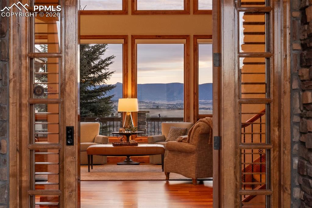 Image 4 of 40: Front Range views unfold immediately upon entering the residence, framed by