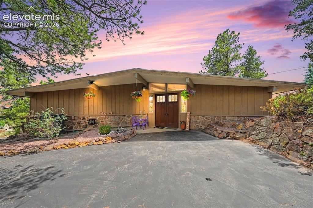 Caption: Charming ranch-style home tucked away among mature pine trees
