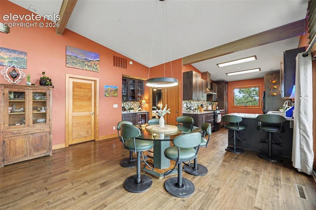 Image 12 of 30: The spacious dining area is perfectly positioned between the living room an