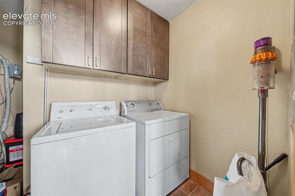 Image 20 of 30: The dedicated laundry room adds convenience and organization with built-in