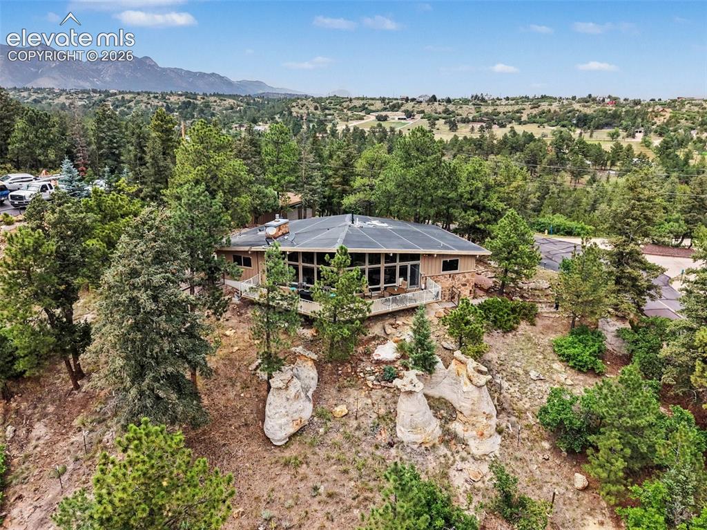 Image 23 of 30: The aerial view showcases the peaceful setting of the home, surrounded by m