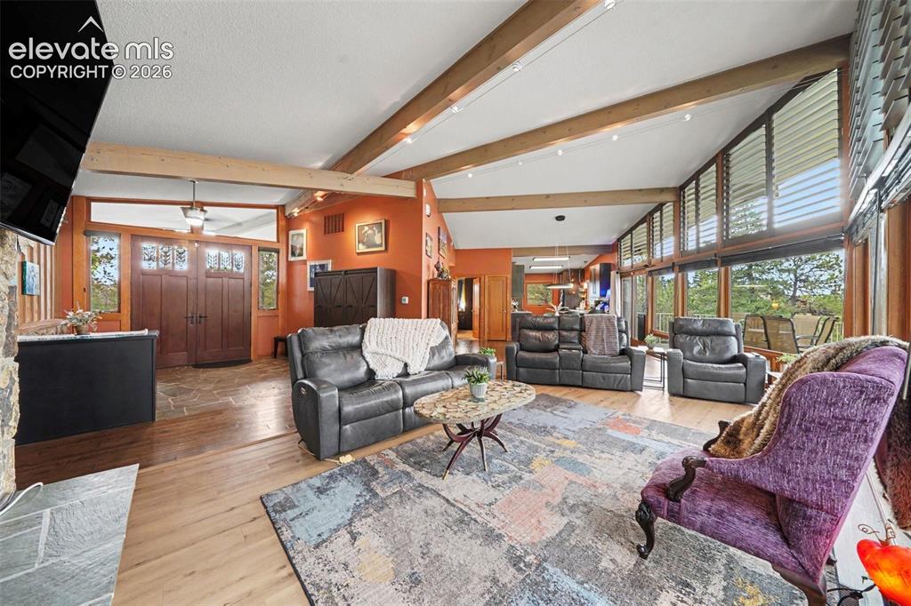 Image 9 of 30: The spacious layout seamlessly connects the living room, dining area, and k