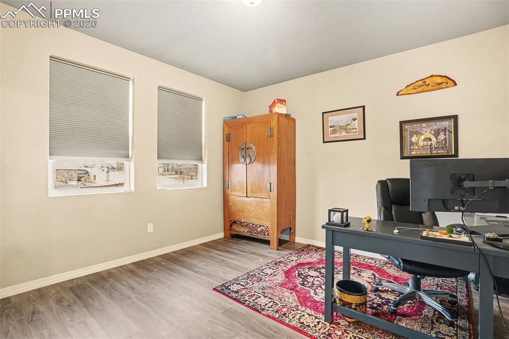 Image 16 of 35: Office with light wood-style flooring and baseboards