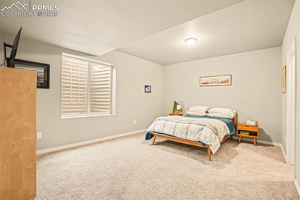 Image 17 of 35: Bedroom featuring carpet floors and baseboards