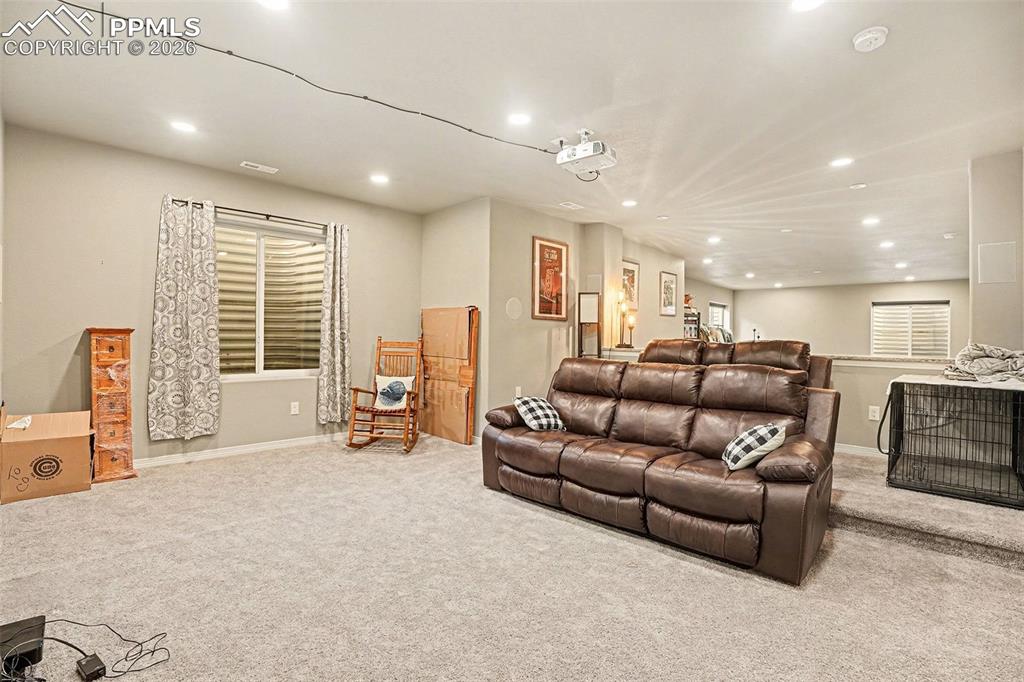 Image 22 of 35: Carpeted living room with recessed lighting