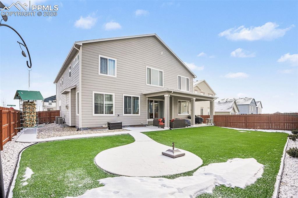 Image 26 of 35: Rear view of house featuring a patio area and a fenced backyard