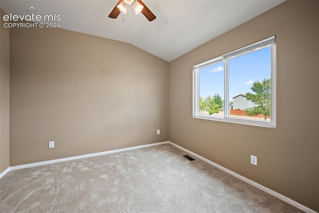Image 16 of 41: Alternate angle of the upstairs bedroom highlighting the closet space, vaul