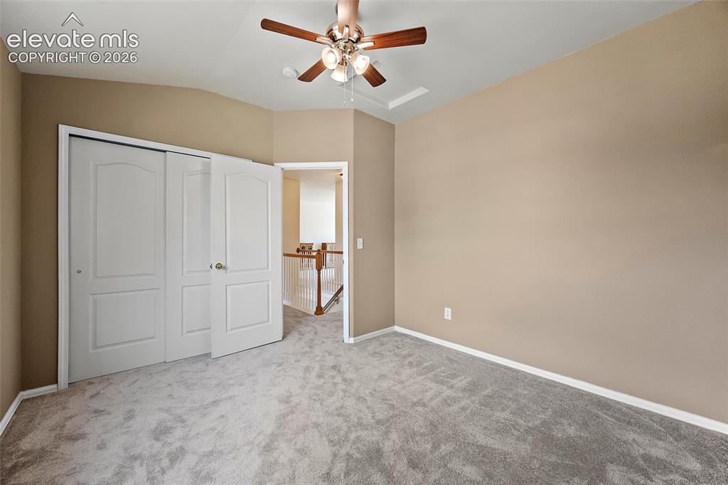 Image 17 of 41: Alternate angle of the upstairs bedroom highlighting the closet space, vaul