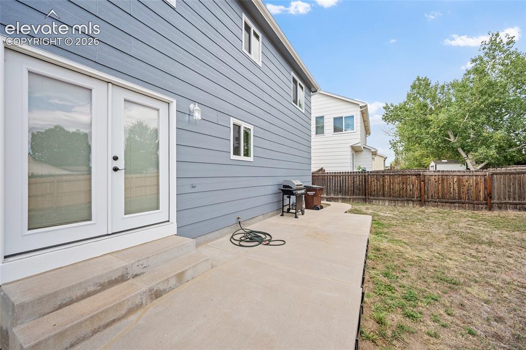 Image 27 of 41: Rear patio with direct access from the home, concrete entertaining space, f