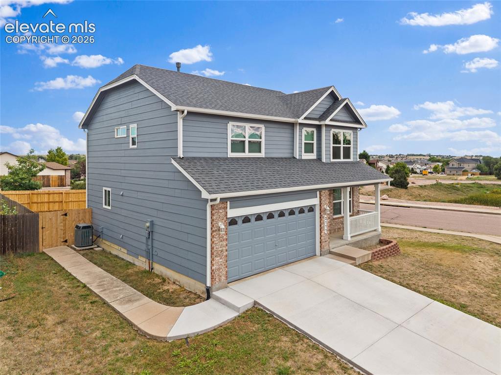 Image 31 of 41: Angled aerial view highlighting the home’s corner-lot setting, two-car gara