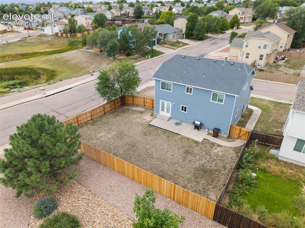 Image 33 of 41: Aerial rear view showcasing the size of the fenced backyard, patio area, an