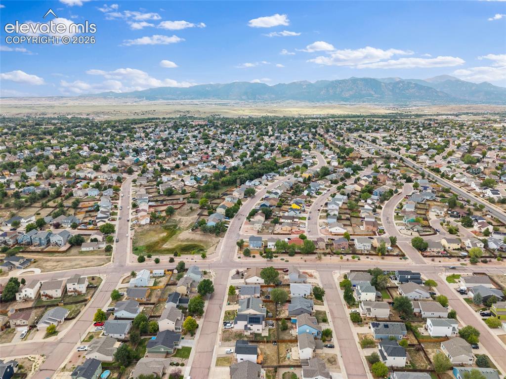 Image 35 of 41: Wide aerial view of the surrounding neighborhood with Front Range mountain