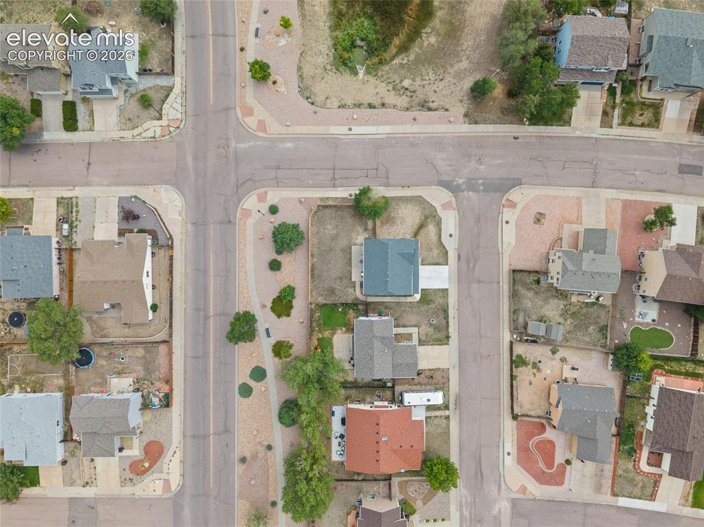 Image 37 of 41: Overhead aerial view showing the home’s corner-lot location and surrounding