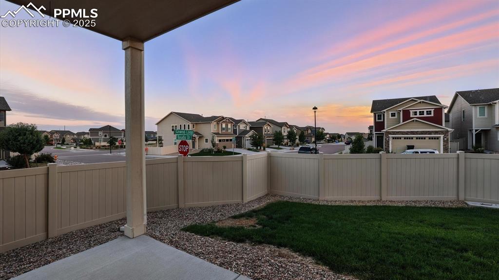 Image 14 of 47: View of the backyard from the covered patio.