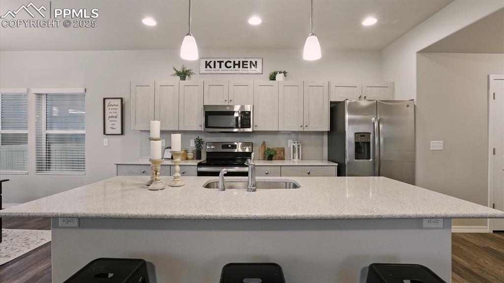 Image 19 of 47: Beautiful quartz island with counter bar for informal dining.
