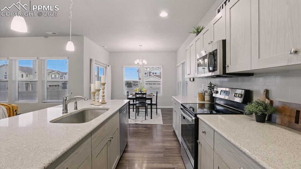 Image 20 of 47: Appliances include a smooth top range oven, dishwasher, built-in microwave 