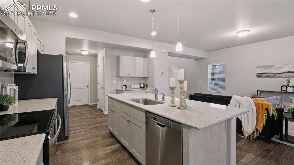 Image 21 of 47: The Kitchen overlooks the Living Room making it easy for the chef to join t