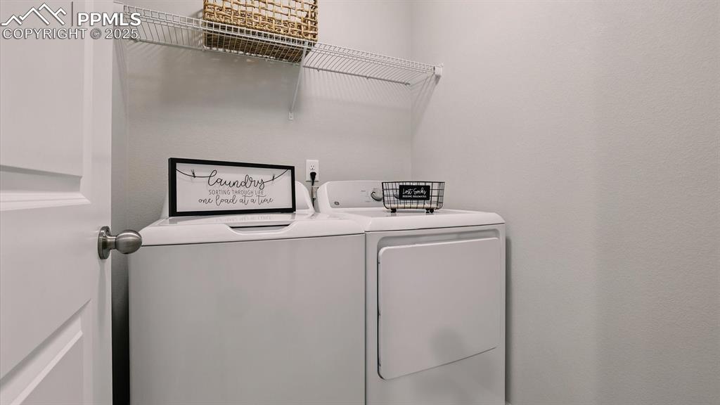 Image 25 of 47: Upper Level Laundry Room with washer and dryer.