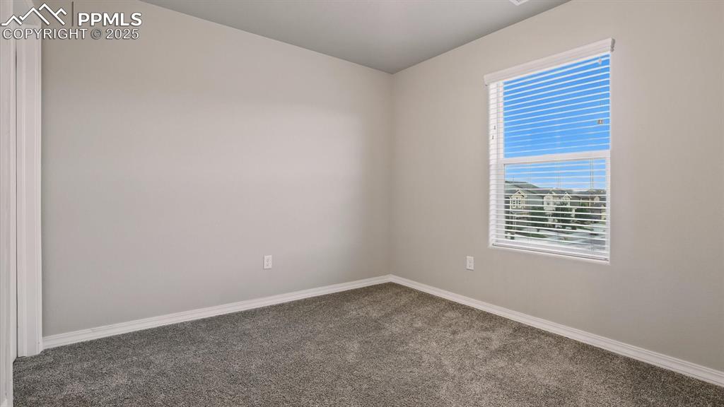 Image 32 of 47: Upper Level Bedroom #2 with neutral carpet.