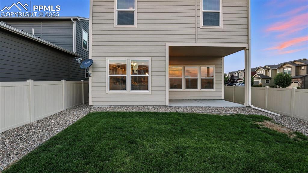 Image 40 of 47: Rear view of home and backyard.