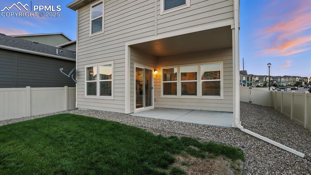 Image 41 of 47: Low maintenance backyard with covered patio.