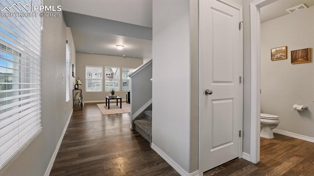 Image 7 of 47: Front entry hallway with coat closet and convenient powder bathroom.